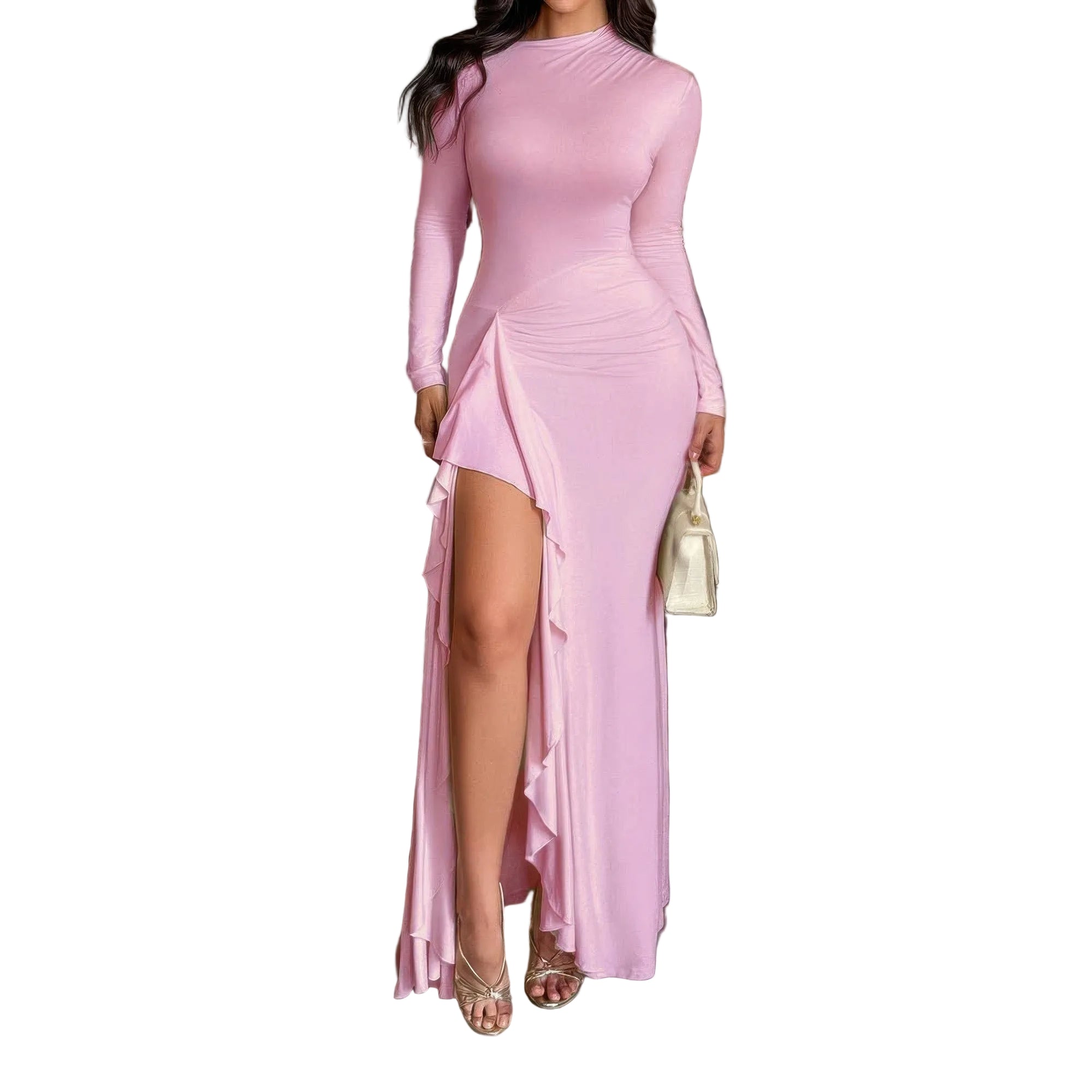 Woman wearing a pink long-sleeve dress with a high slit in a room.