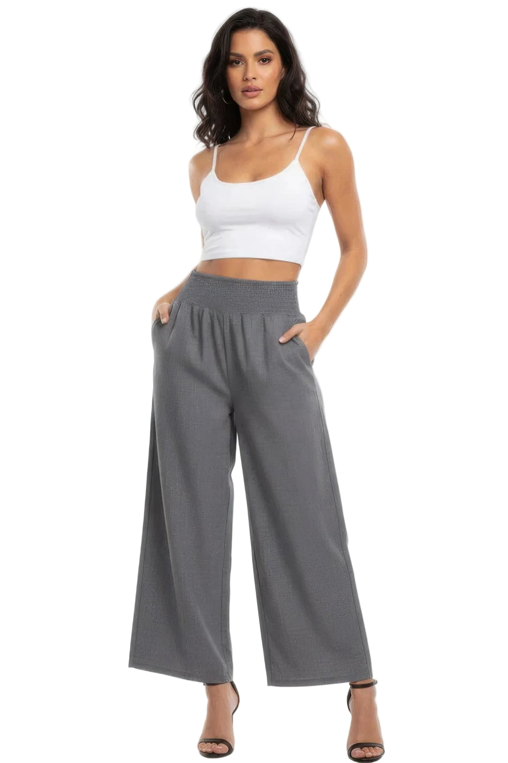 Woman wearing a white top and gray wide-leg pants on a white background