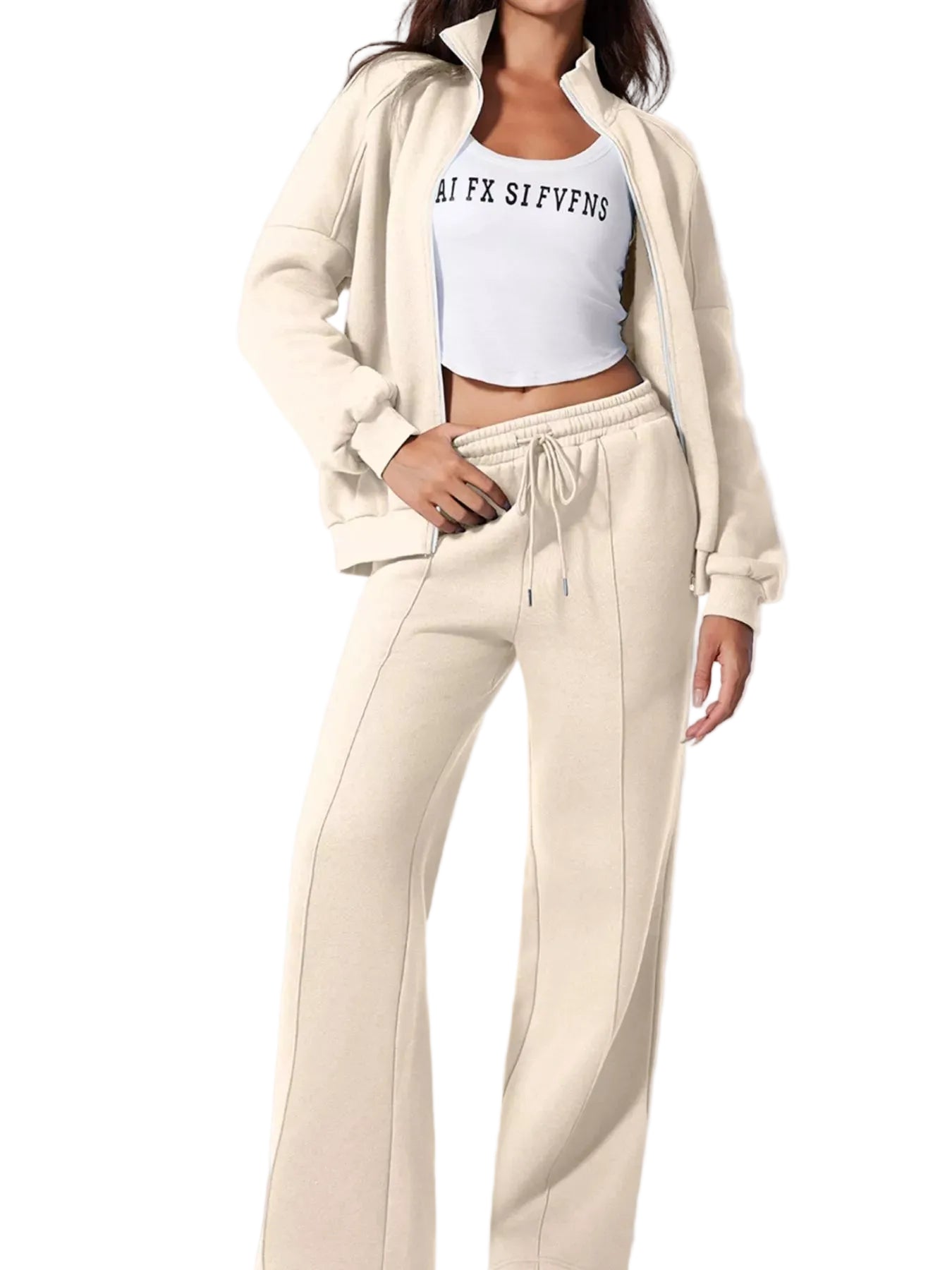 Person wearing a beige tracksuit with a white crop top on a light gray background