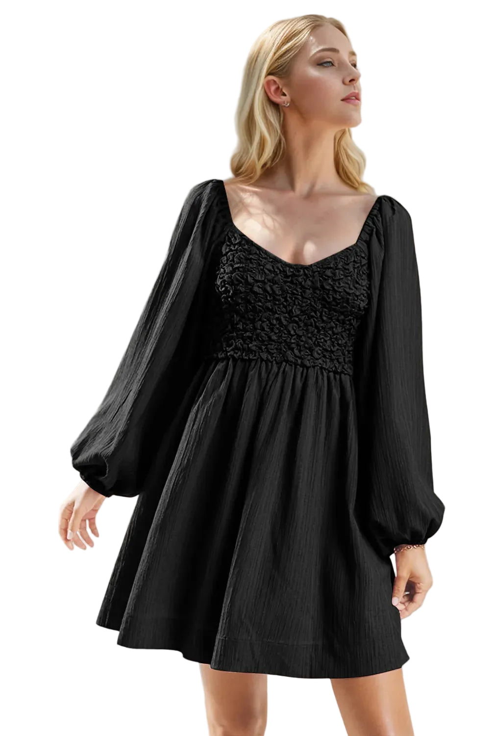 Woman wearing a black dress with puffed sleeves against a neutral background