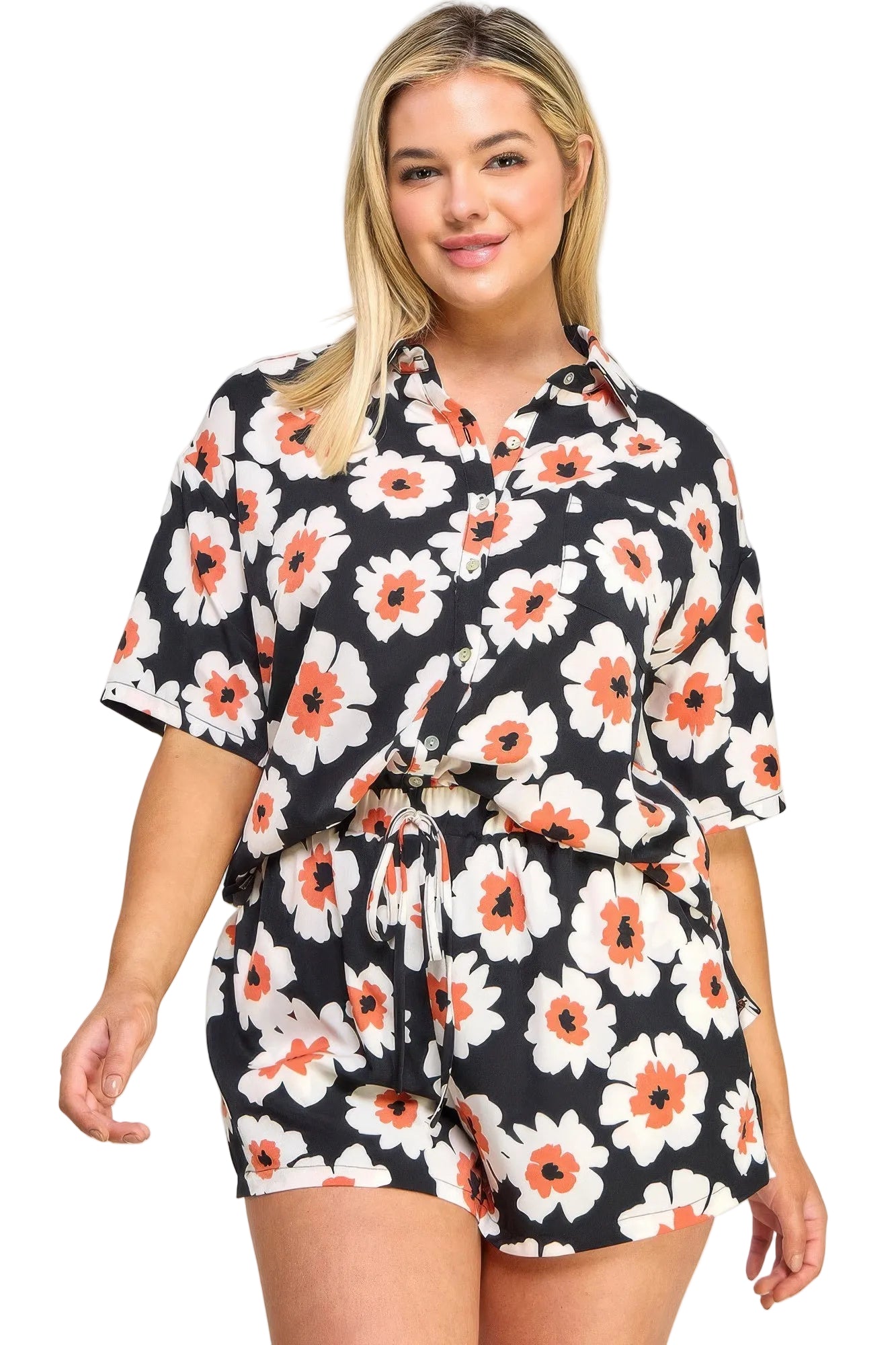 Woman wearing a black floral dress with orange and white flowers on a white background