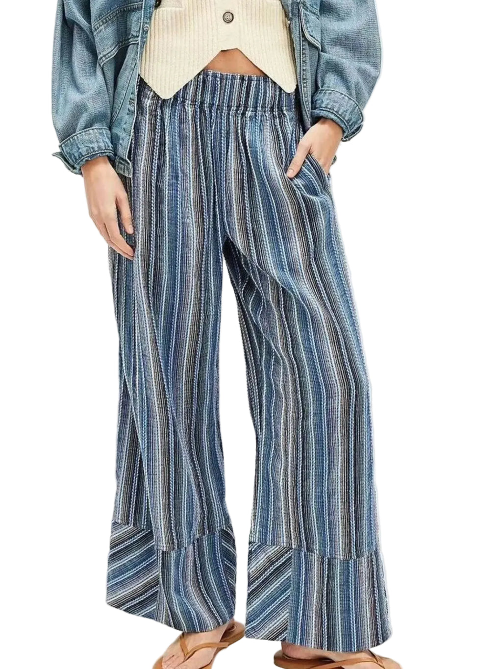 Person wearing blue and white striped wide-leg pants with a denim jacket on a white background