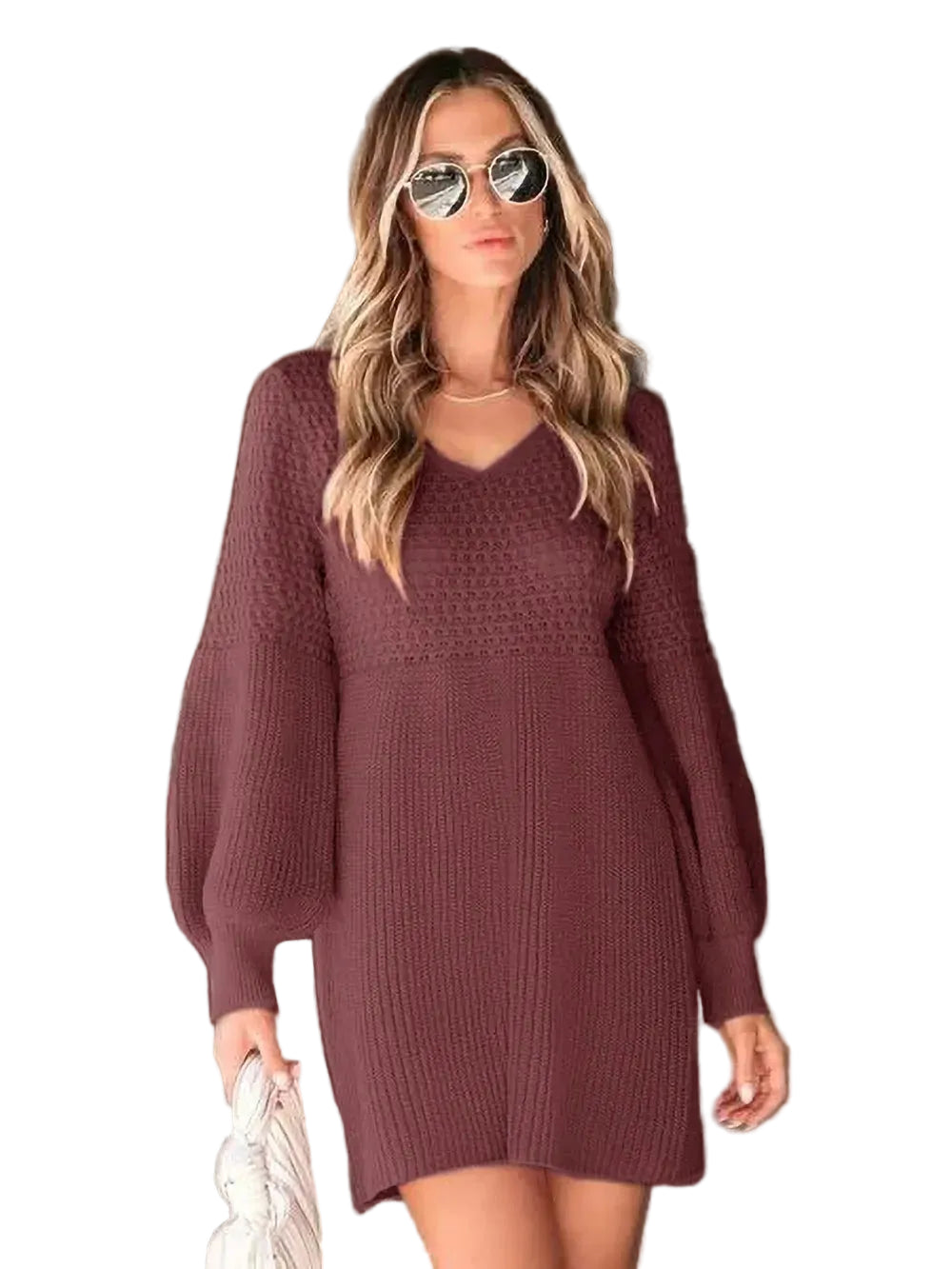 Woman wearing a maroon knitted dress against a neutral background