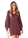 Woman wearing a maroon knitted dress against a neutral background