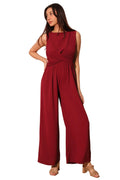 Woman wearing a red jumpsuit against a plain background
