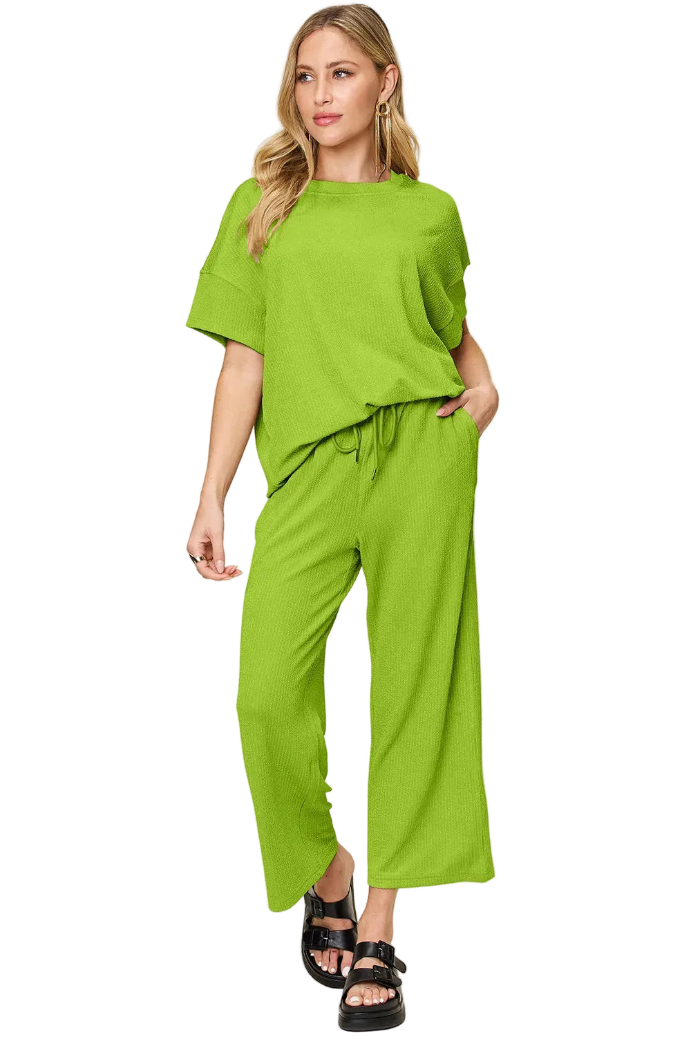 Woman wearing a bright green outfit on a beige background