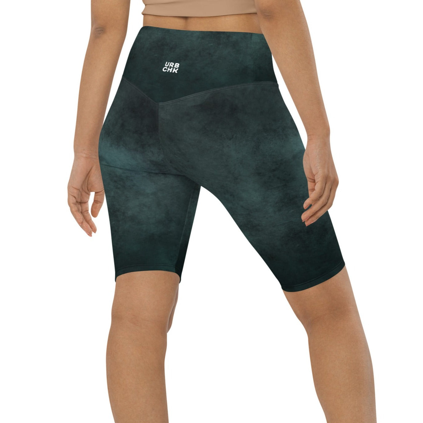 A woman standing wearing biker shorts.