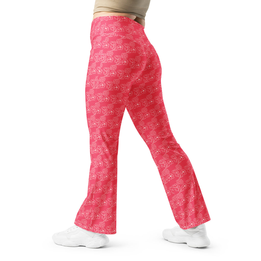 A person wearing pink floral flare leggings with a high-waisted design, walking away from the camera.