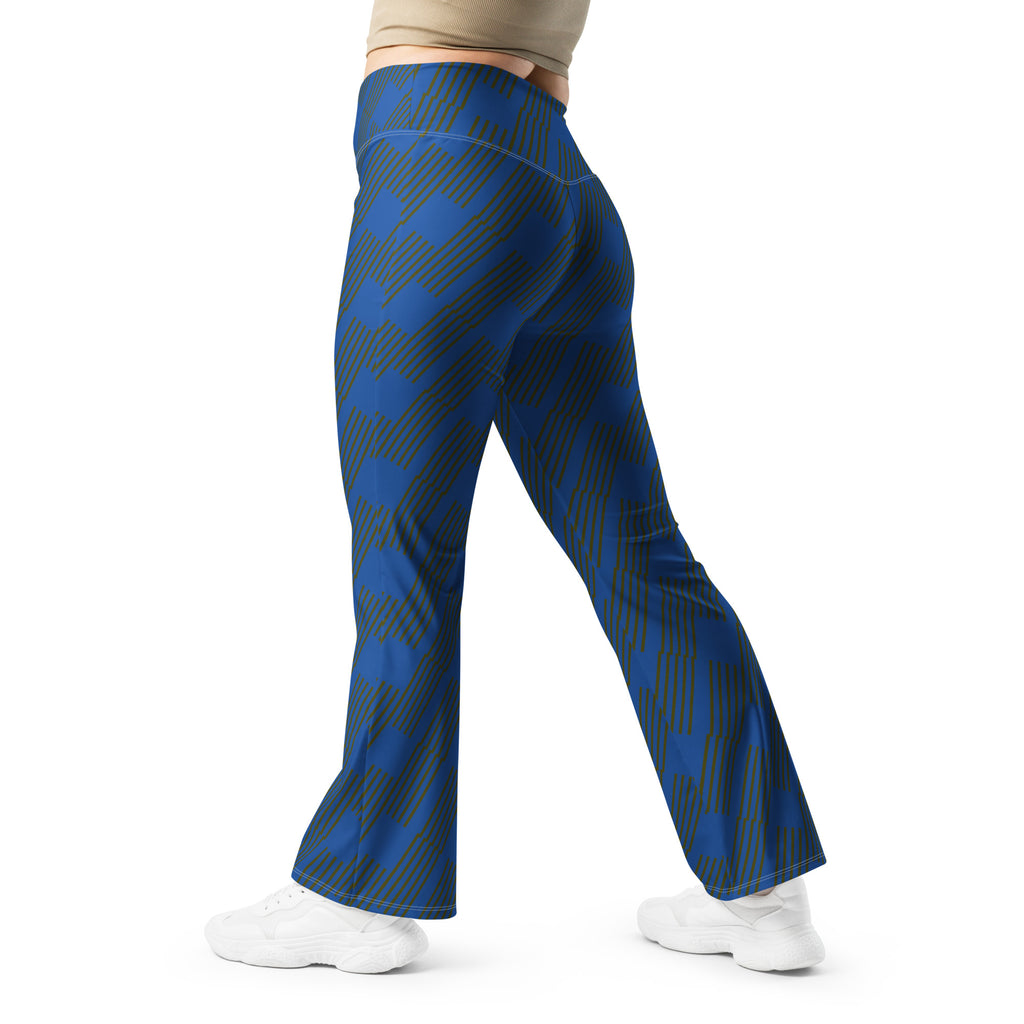 A person wearing blue flare leggings with a geometric pattern, featuring a high-waisted design and a butt-lifting cut. They are also wearing white sneakers.