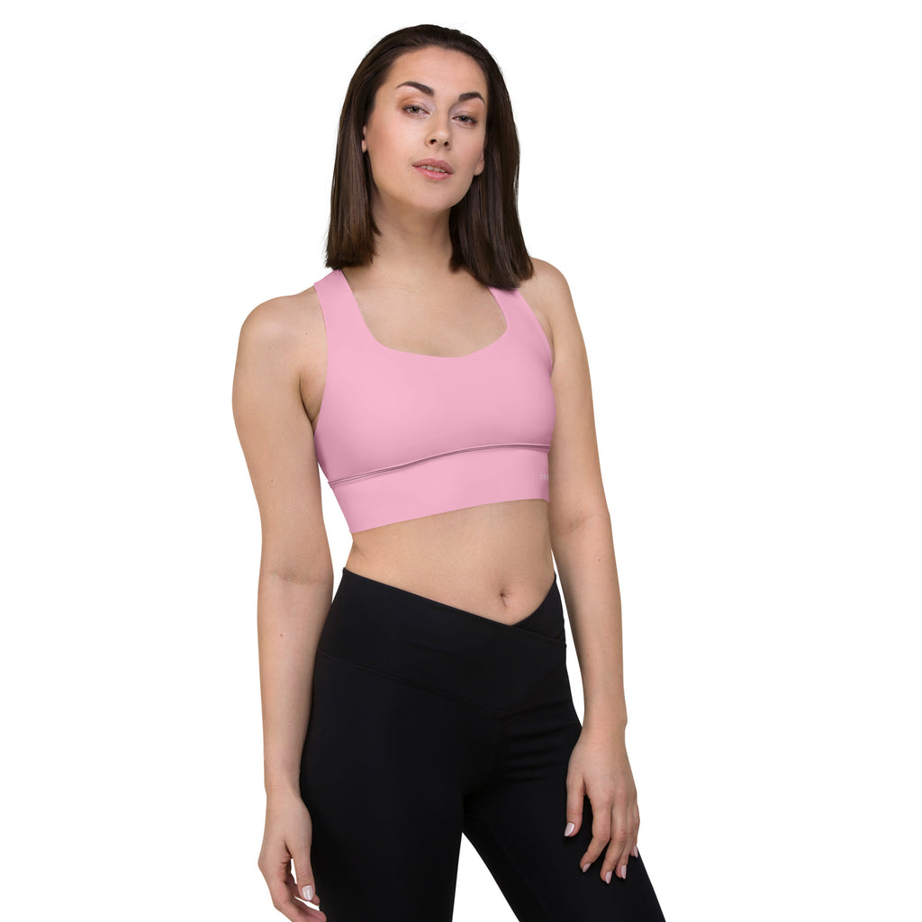 Women Wearing a Pink sleeveless sports bra with strap and white background.