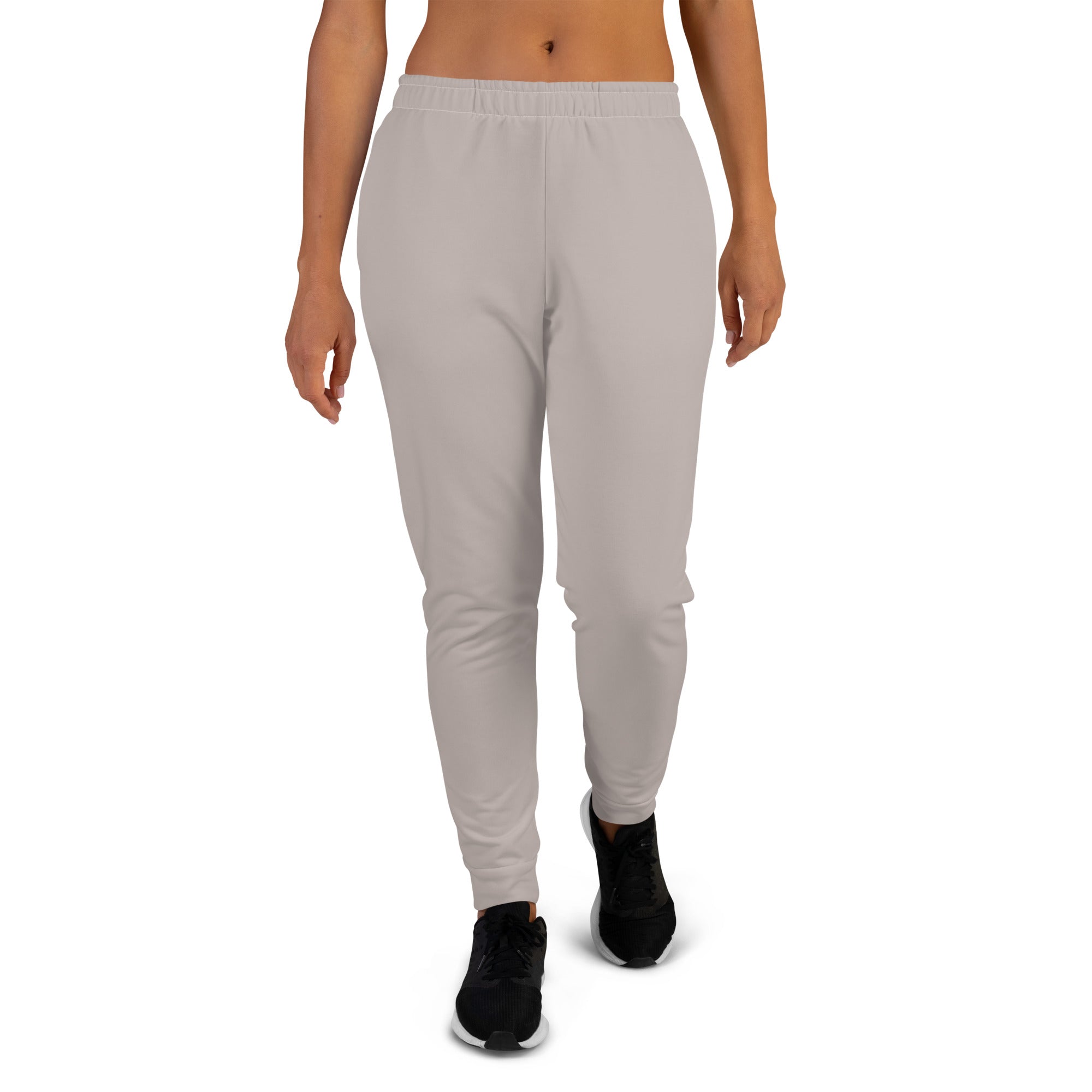  a women wearing a jogger pant with a white background