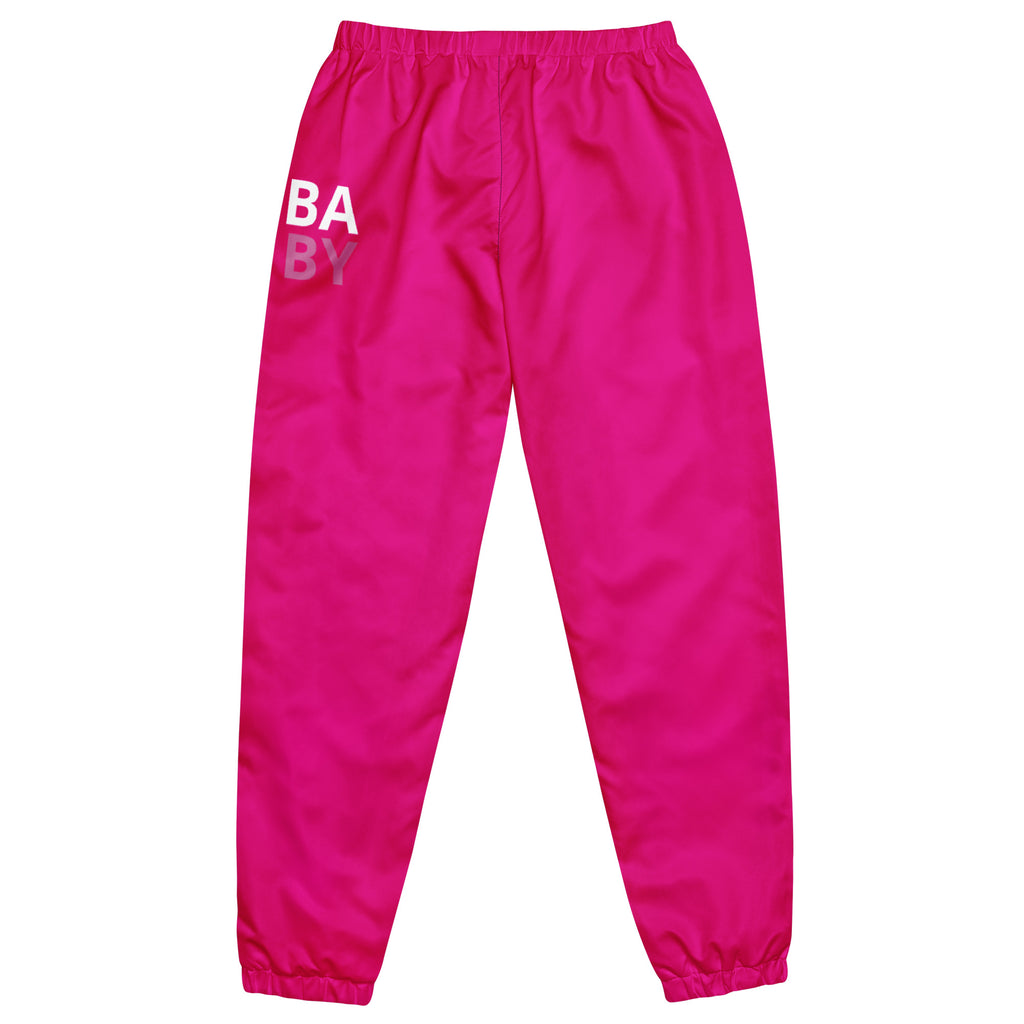 A pair of pink track pants for women with 'BABY' printed on the left leg and a drawcord waistband.