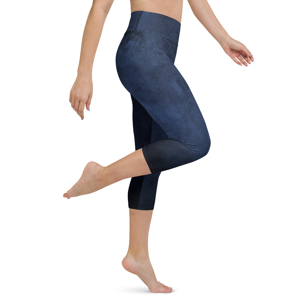 A person wearing blue capri leggings with a high-waisted design, featuring a comfortable fit and mid-calf length.