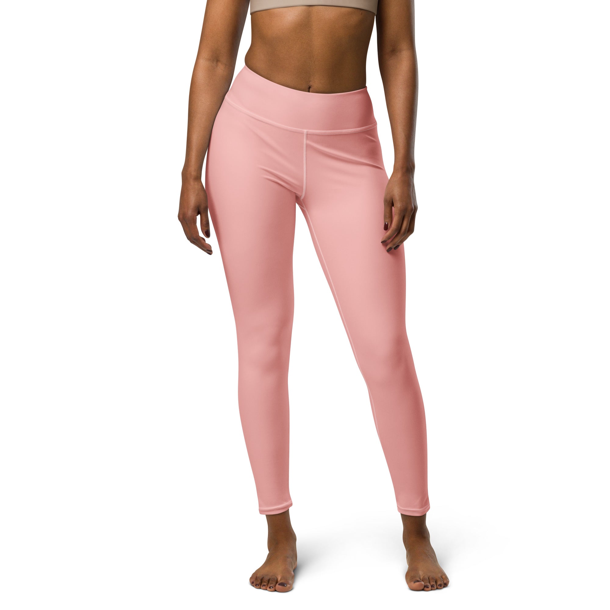 a women wearing a yoga legging with white background.