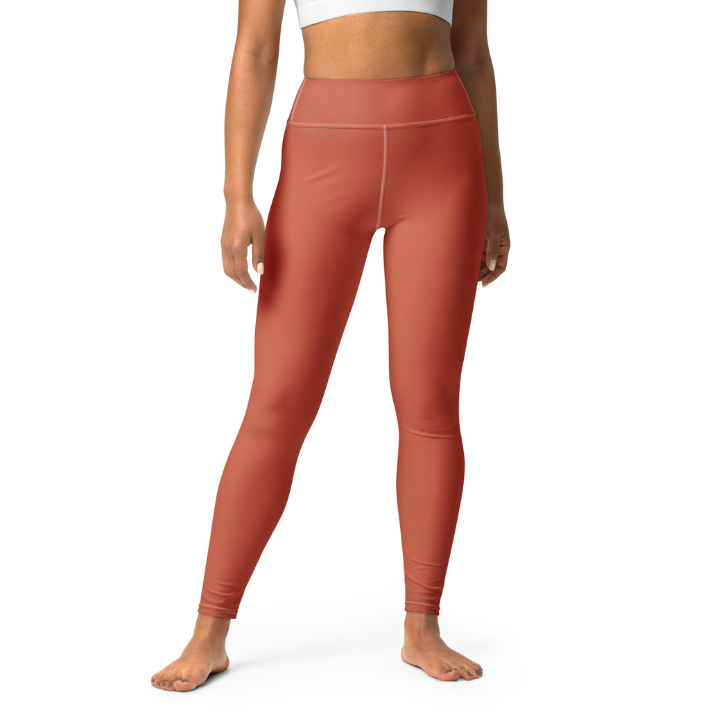 A pair of women's high-waisted leggings in a brown color, featuring a smooth texture and a raised waistband.