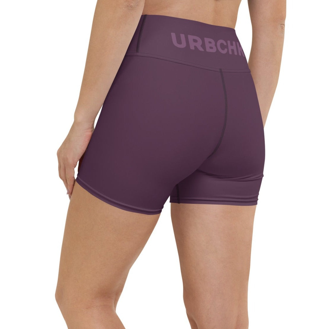 a women wearing yoga shorts with white background.