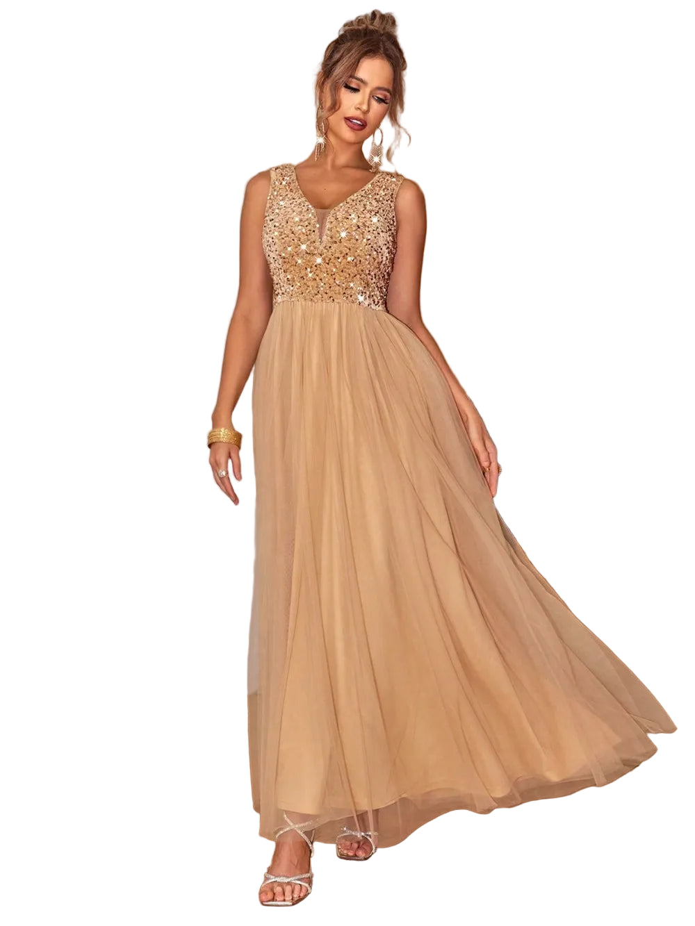 Woman wearing a beige evening gown with gold embellishments in an indoor setting.