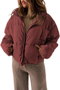 Person wearing a burgundy puffer jacket on a plain background