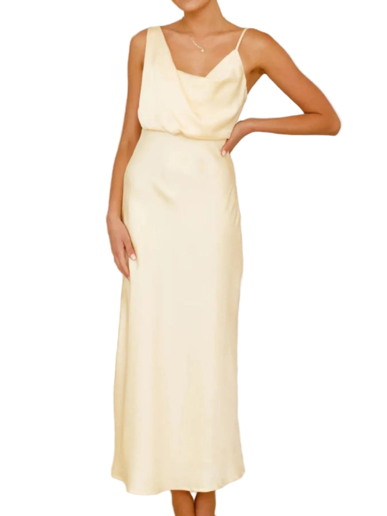 Woman wearing a light yellow dress standing on a staircase.