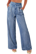 Person wearing blue wide-leg jeans on a white background