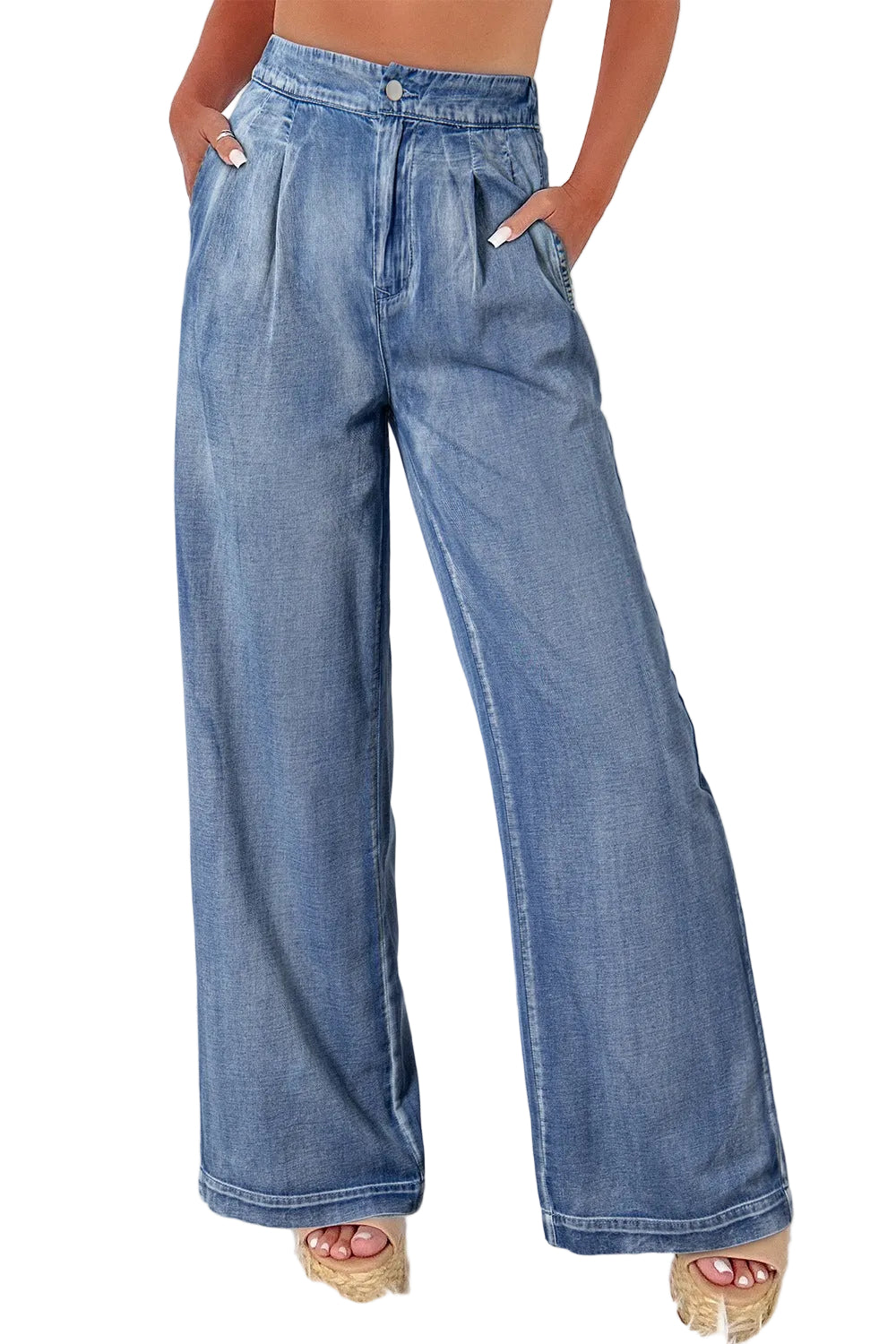 Person wearing blue wide-leg jeans on a white background
