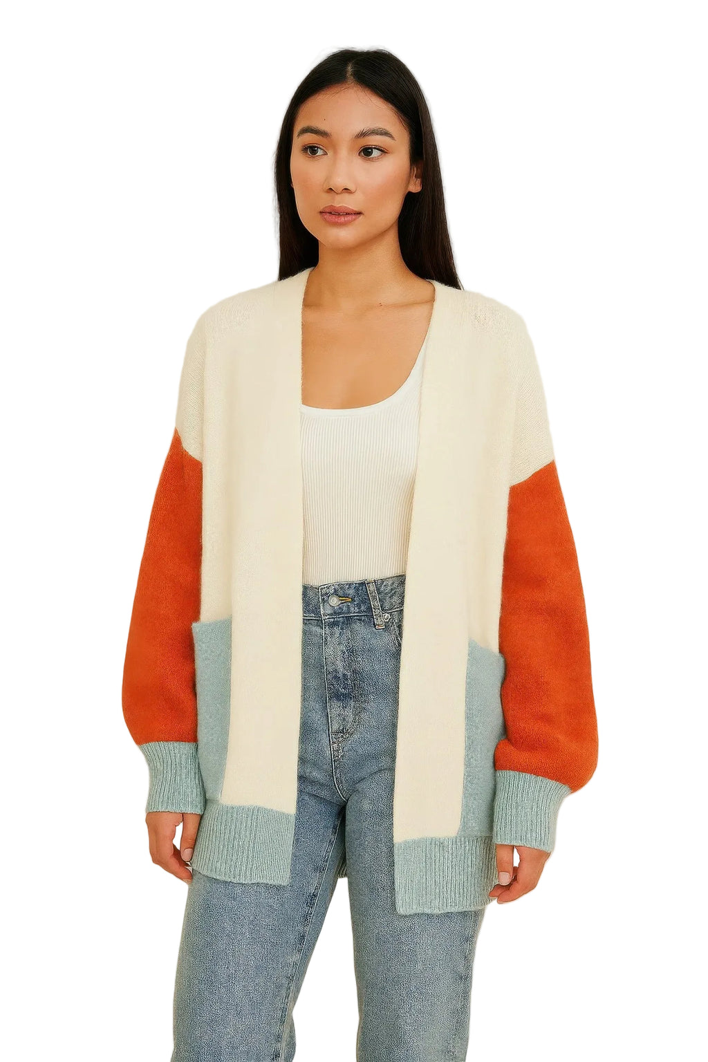 A woman modeling a color-block knit cardigan with cream, orange, and light blue sections, worn open over a white tank top and light-wash blue jeans against a plain off-white background.